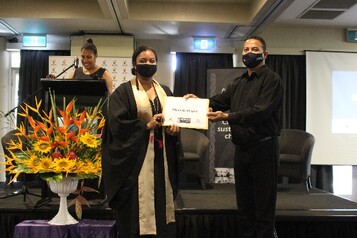 Elizabeth Asigau receiving her certificate