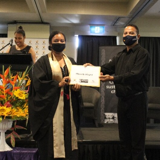 Elizabeth Asigau receiving her certificate