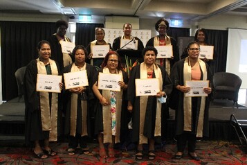 Cohort 13 graduates display their Australian accredited certificates